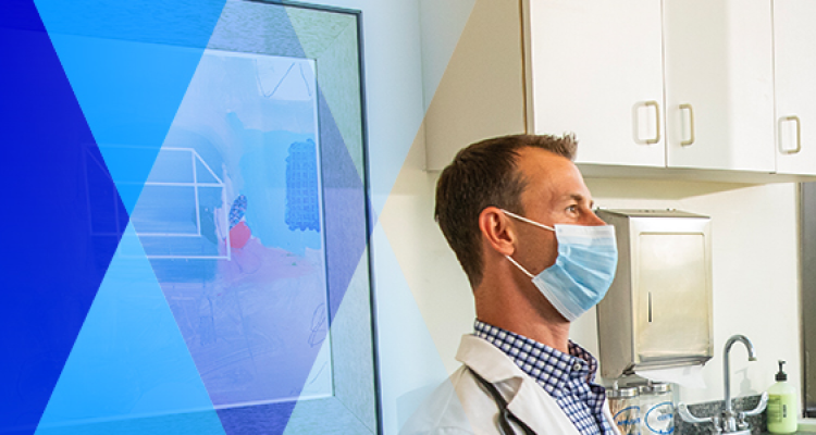 A masked doctor in a medical room looks off into the distance as blue graphic triangles fade in from the left.